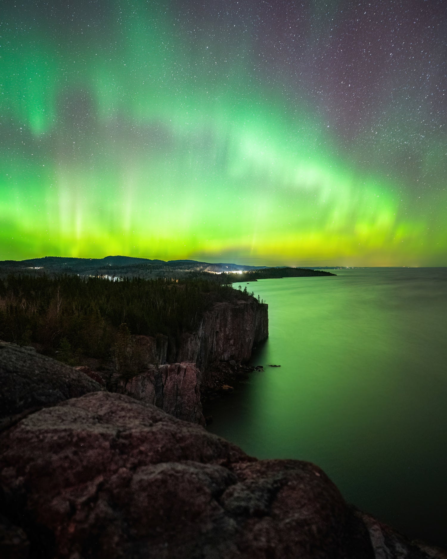 Bright green and purple aurora borealis over Lake Superior in Minnesota. Photo captured by Vincent Ledvina, The Aurora Guy