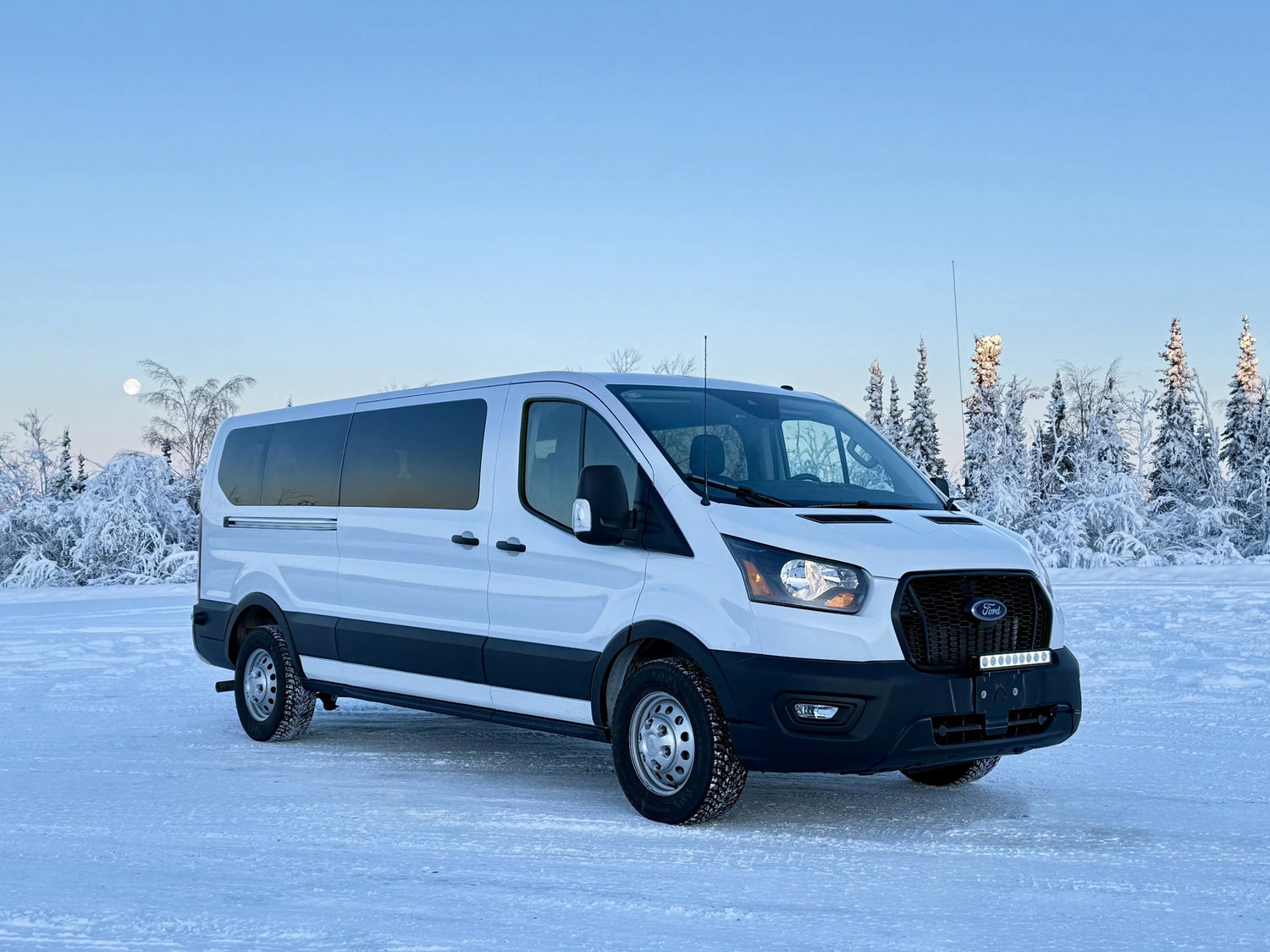 The Midnight Sky Adventures all-wheel-drive touring van parked in snow near Fairbanks, Alaska
