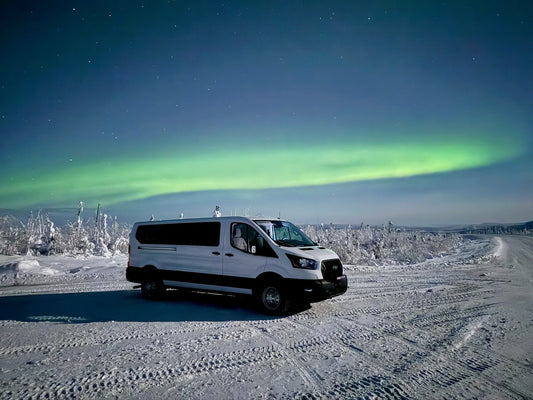 The Midnight Sky Adventures touring van parked under a green auroral arc on the Dalton Highway north of Fairbanks, Alaska 2